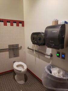 Bathroom layout showing handle bars by toilet and toilet paper dispenser above the handle bars