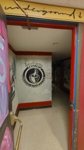 Entrance to Bob's Underground from door to turn in hallway.