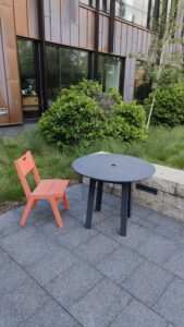 Chair and table by limestone seat wall