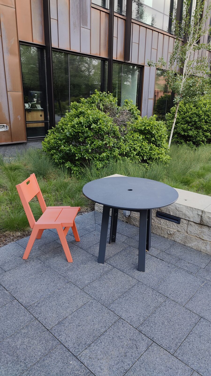 Chair and table by limestone seat wall