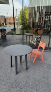 Chair and table set pictured near eastern entrance to HSSC.