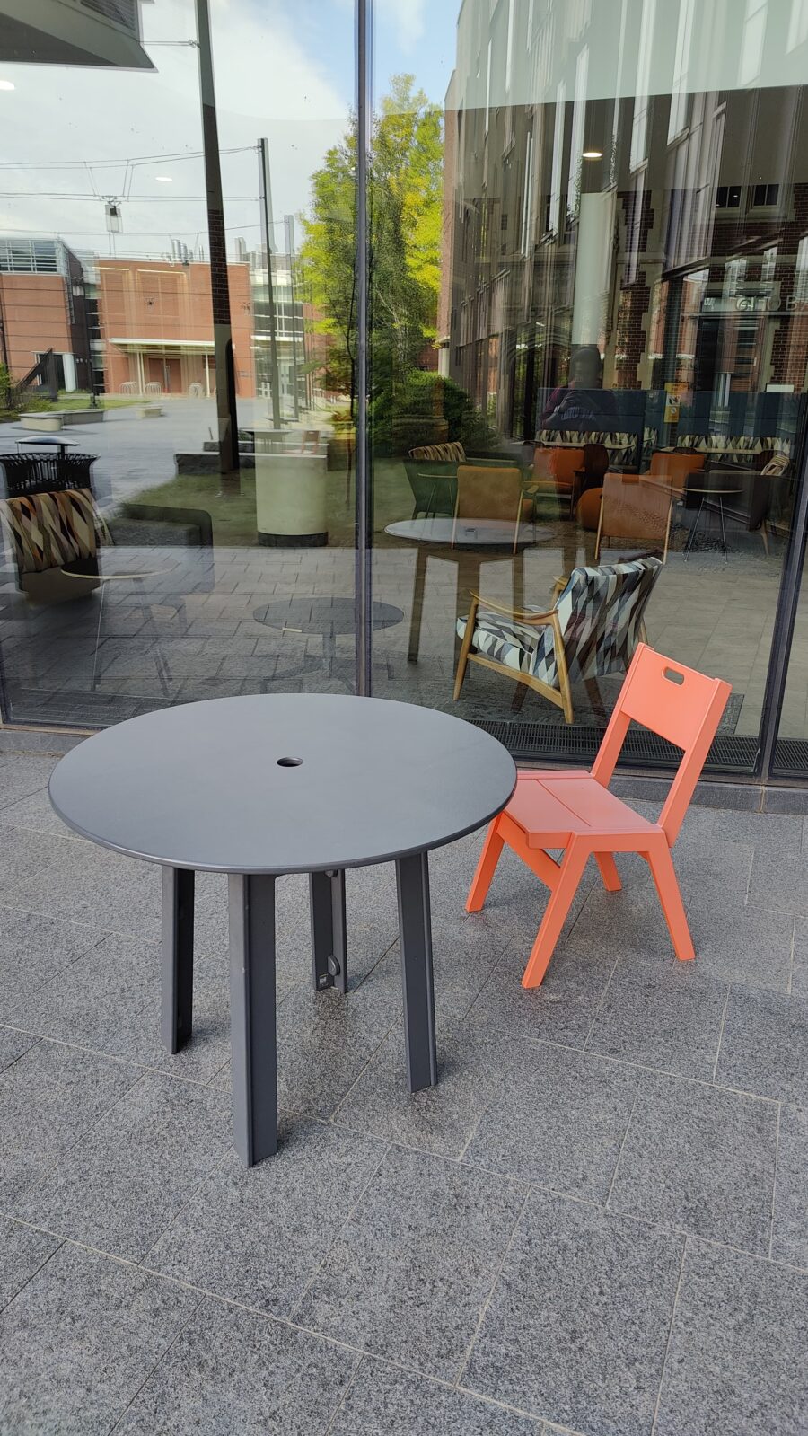 Chair and table set pictured near eastern entrance to HSSC.