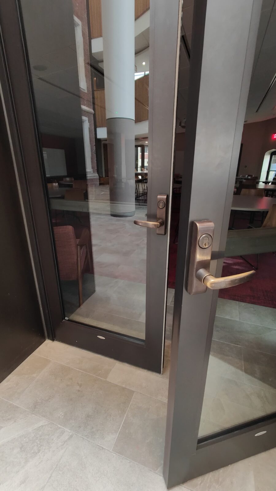 One of the doors leading to the HSSC multipurpose room, showing the opening mechanism which is a lever handle.
