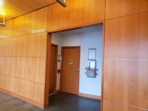 Accessible restrooms are doors closest to and on either side of fire extinguisher