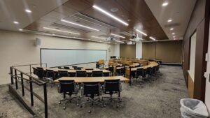 View of room as you enter, with ramp to access the front of the room to the left, or smooth floor to right to move around the room.