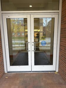 The view of the doors leading into the mailroom. The right most door is the one that opens with the push button door opener. 
