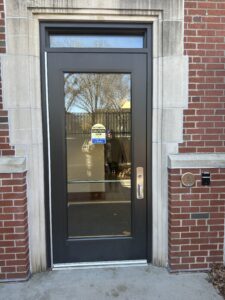 Younker Hall entrance door accessed by the accessible ramp. Automatic door opener and p-card reader to right of door exterior.