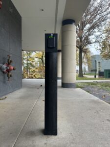 The automatic door opener is a free-standing column to the right as you approach the door.
