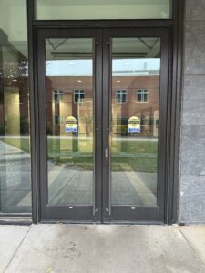 Exterior of the double doors at the entrance to the HSSC across from the Noyce bike racks.
