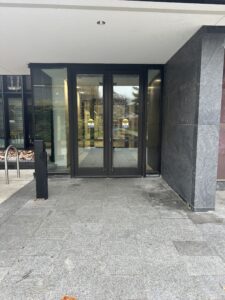View of doors with push/kick automatic door opener stand on left.