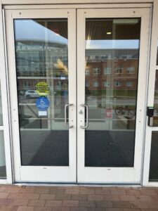 The left most door is the one that is controlled by the automatic door opener. The automatic door opener does open both sets of doors to a delayed response (the first door opens and then approx. 5 seconds later the 2nd door opens). 