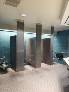 Bathroom stalls, with accessible stall on far right