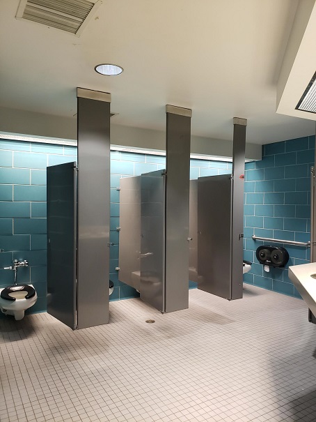 Bathroom stalls, with accessible stall on far right