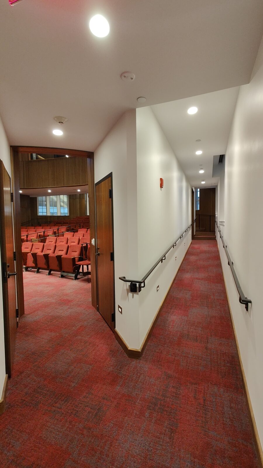 Ramp leading to front of audience seating area in HSSC Auditorium, continuing to back seating area if you proceed past the first doors.