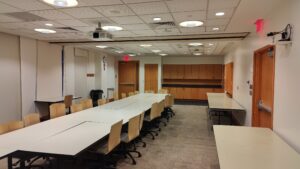 View of the room from the end farthest from the described entrance door, which is visible in the far left of the picture.