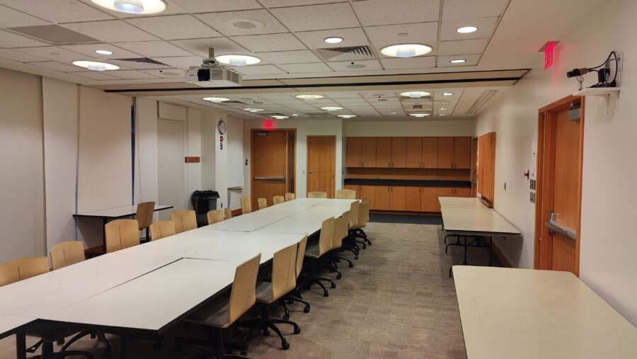 View of the room from the end farthest from the described entrance door, which is visible in the far left of the picture.