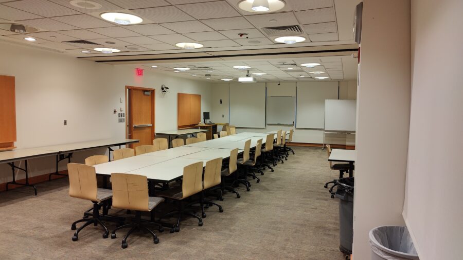 View of room as you enter from the doors closest to the elevator, with the standard set-up with the long tables in the center.
