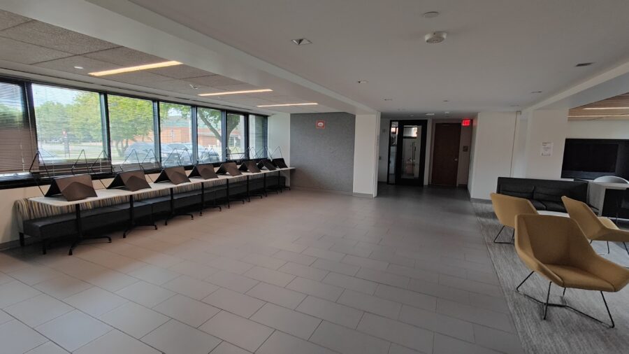 Norris Lounge with bank of table and seating area on left, carpeted lounge area to right